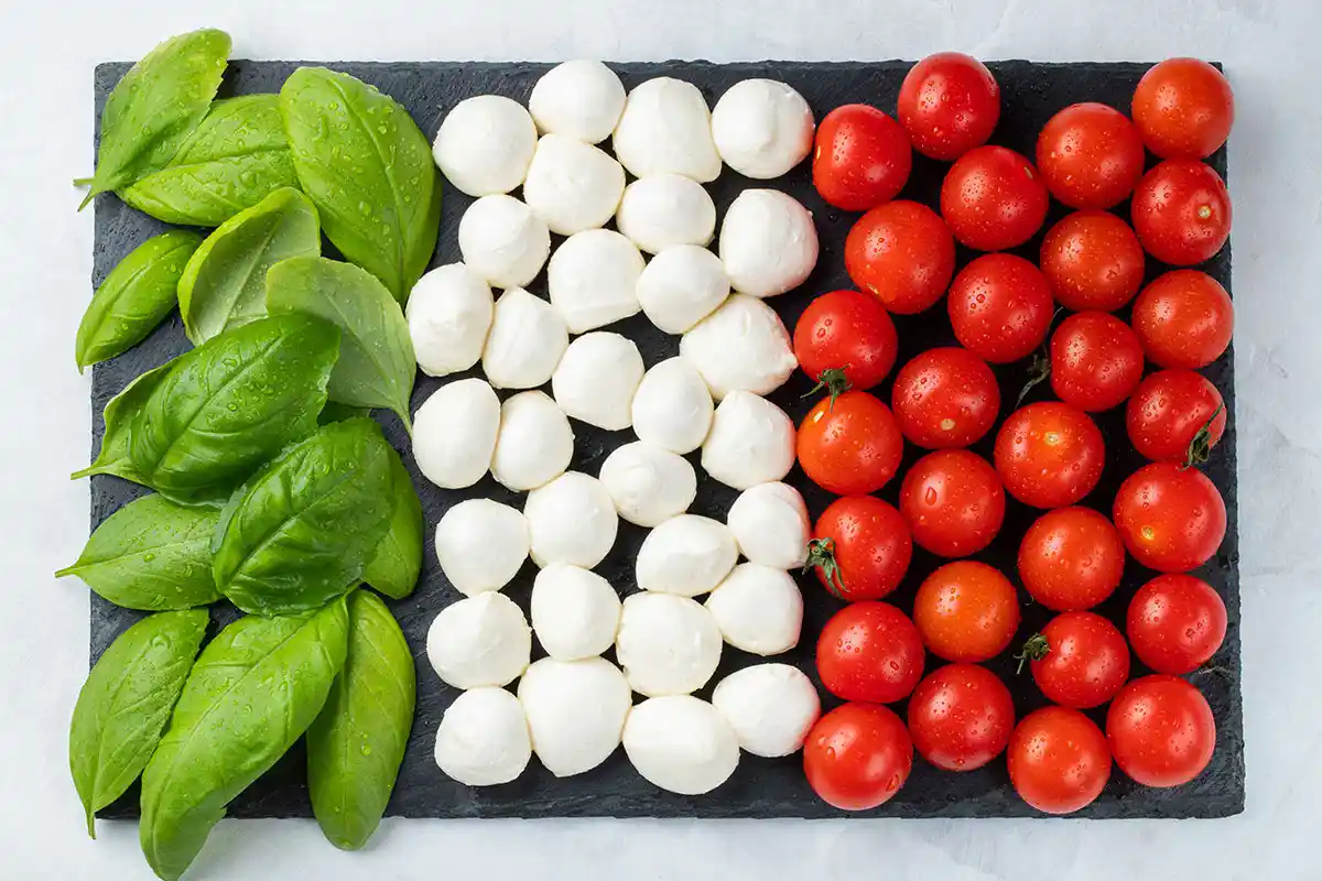 Italian flag made out of pizza topping ingredients